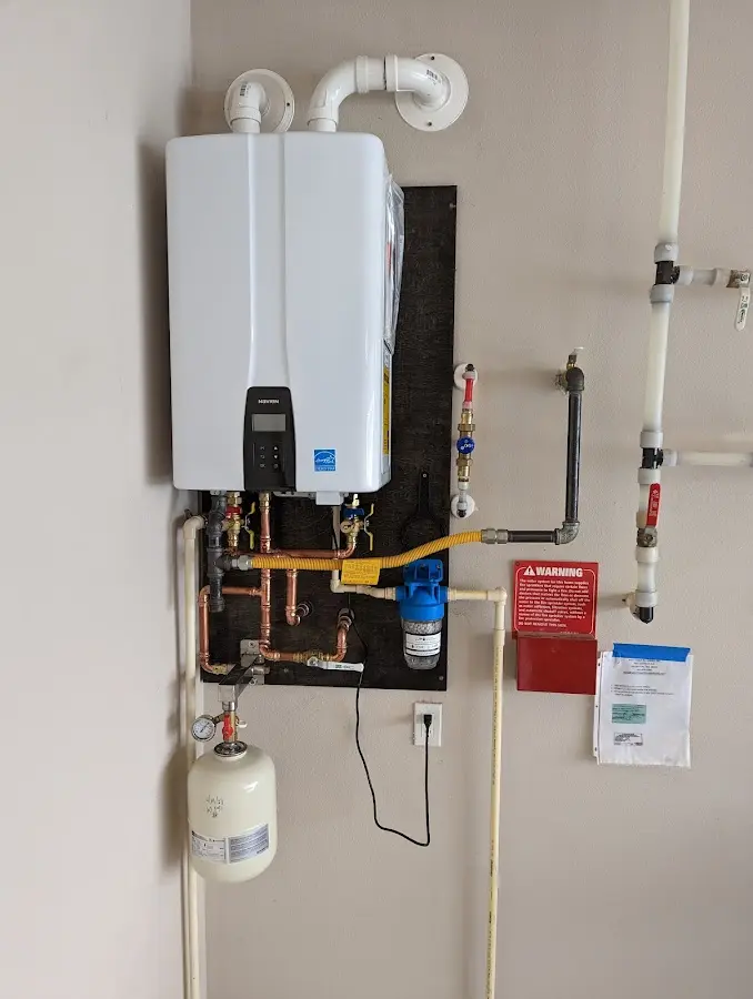 Professional plumber installing copper piping in a Cherryvale home
